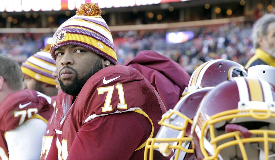 Washington Redskins tackle Trent Williams (71) watches the action from the bench during the first half of an NFL football game against the St. Louis Rams in Landover, Md., Sunday, Dec. 7, 2014. (AP Photo/Mark Tenally) ** FILE **