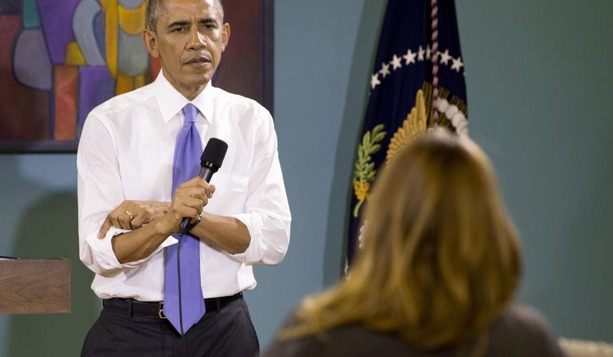 President Obama rolls up his sleeves while being asked a question about his recent executive actions on immigration at Casa Azafran in Nashville, Tenn., on Dec. 9, 2014. (Associated Press) **FILE**