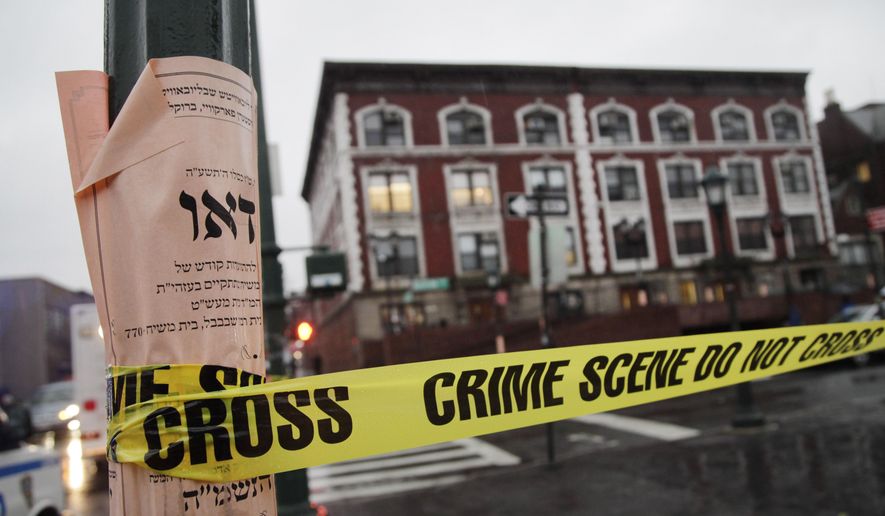 Crime scene tape is wrapped around a pole in front of Chabad-Lubavitch Hasidic headquarters, Tuesday, Dec. 9, 2014, in New York. A knife-wielding man stabbed an Israeli student inside the Brooklyn synagogue before being fatally shot by police after he refused to drop the knife. The student, Levi Rosenblatt, is in stable condition. (AP Photo/Mark Lennihan)