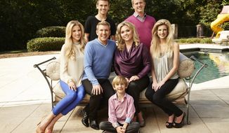This Oct. 2, 2013 photo released by USA Network shows the cast of &#39;Chrisley Knows Best,&#39; back row from left,  Chase Chrisley and Kyle Chrisley, second row from left,  Savannah Chrisley, Todd Chrisley, Julie Chrisley, and Lindsie Chrisley Campbell, and front center Grayson Chrisley, posing in Atlanta. In August, a federal grand jury in Atlanta handed down a 12-count indictment against Mr. Chrisley and his wife Julie on tax evasion and other charges. (AP Photo/USA Network, Tommy Garcia)