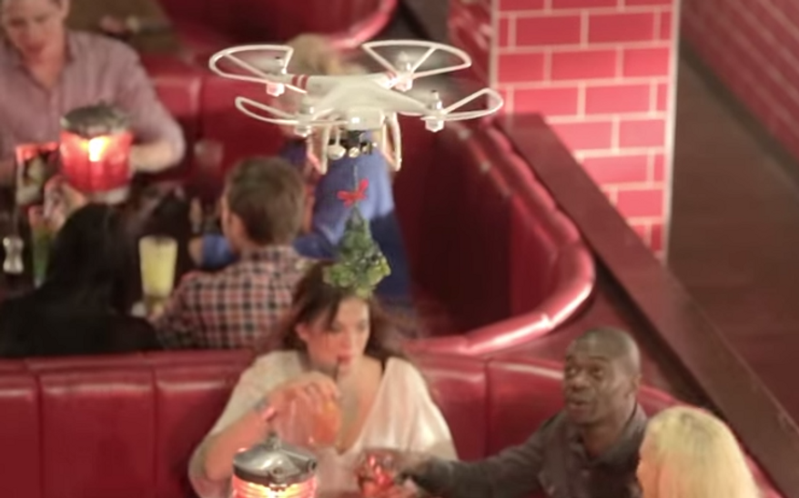 A Brooklyn photojournalist reportedly had a piece of her nose severed off by a wayward drone carrying mistletoe during a promotional event at TGI Friday's. (YouTube/TGI Friday's)