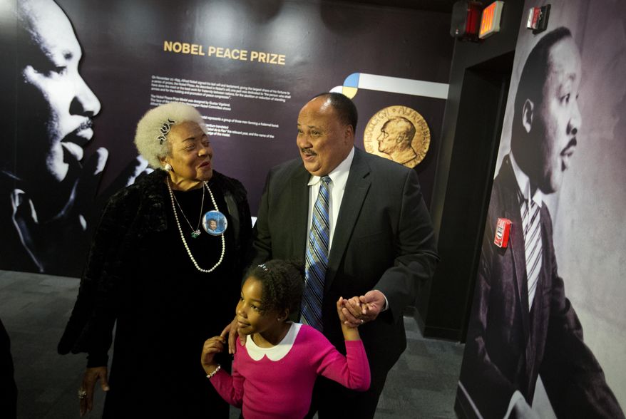 Martin Luther King III, right, the son of Rev. Martin Luther King Jr., walks with his daughter Yolanda, and Naomi King, the wife of Rev. King's brother, A.D., through an exhibition devoted to the awarding of the Nobel Peace Prize to King at the Martin Luther King Jr. Historical Site, Wednesday, Dec. 10, 2014, in Atlanta. (AP Photo/David Goldman) ** FILE **