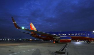In this Nov. 13, 2014 photo, a Southwest Airlines originator flight pulls from the gate for departure from Love Field in Dallas. Throughout the airline industry, the first flight of the day sets the tone for keeping the system&#39;s flights running on-time. (AP Photo/LM Otero)