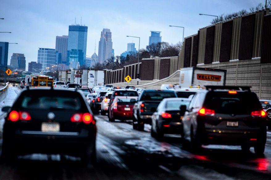 In this Monday, Nov. 10, 2014 file photo, traffic crawls into downtown Minneapolis, Minn from the south along I-35W as an early snow was compressed into a slippery mess. State legislators are working on ways to better identify Minnesota residents who drive without auto insurance. Motorists don't have to show proof of insurance when renewing a vehicle's registration. People who drive without insurance can lose their licenses and be fined about $300. (AP Photo/The Star Tribune, Glen Stubbe, File)