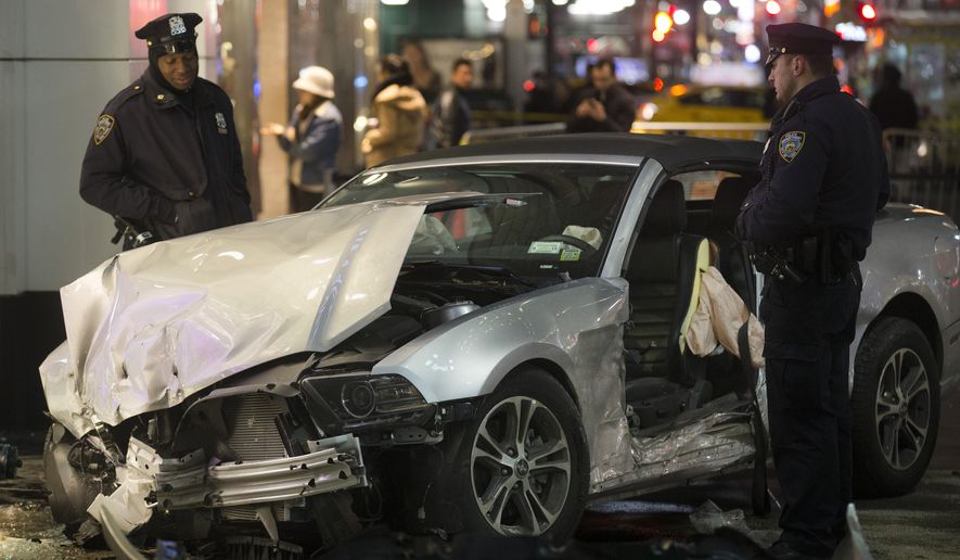 Police stand guard at the scene of a vehicular accident on 34th Street, Thursday, Dec. 11, 2014, in New York. Six people were hurt when the car jumped a curb in midtown Manhattan and struck a group of people around 10 p.m. A fire department spokesman says the injured were taken to Bellevue hospital with serious but non-life threatening injuries. (AP Photo/John Minchillo)