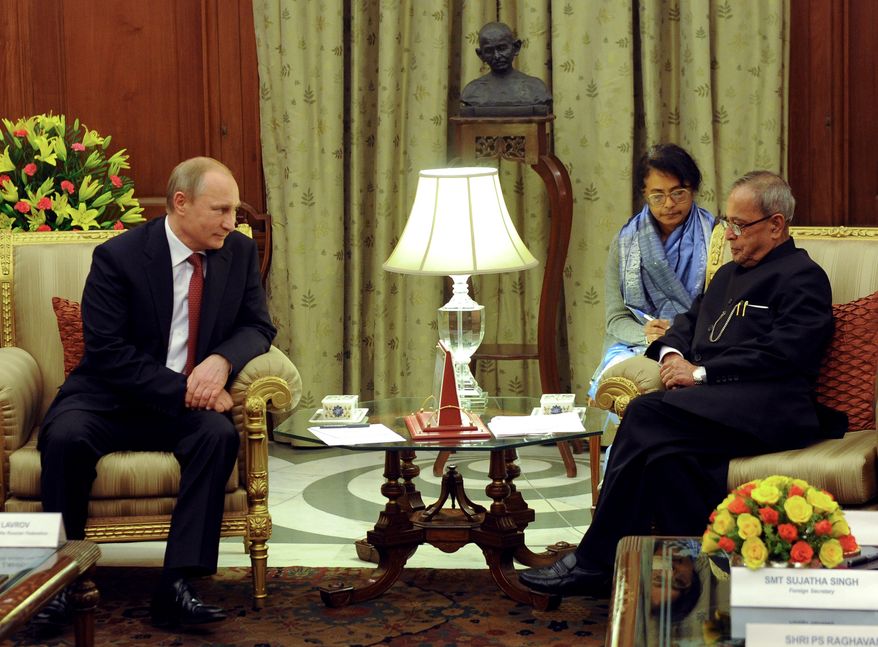 Russian President Vladimir Putin, left, and Indian President Pranab Mukherjee meet in New Delhi, India, Thursday, Dec. 11, 2014. Facing a stumbling economy at home and increasingly biting Western sanctions, Russian President Vladimir Putin sought Thursday to strengthen once-close relationship with India through an ambitious plan to help New Delhi build at least 12 new nuclear reactors. (AP Photo/RIA Novosti Kremlin, Mikhail Klimentyev, Presidential Press Service)