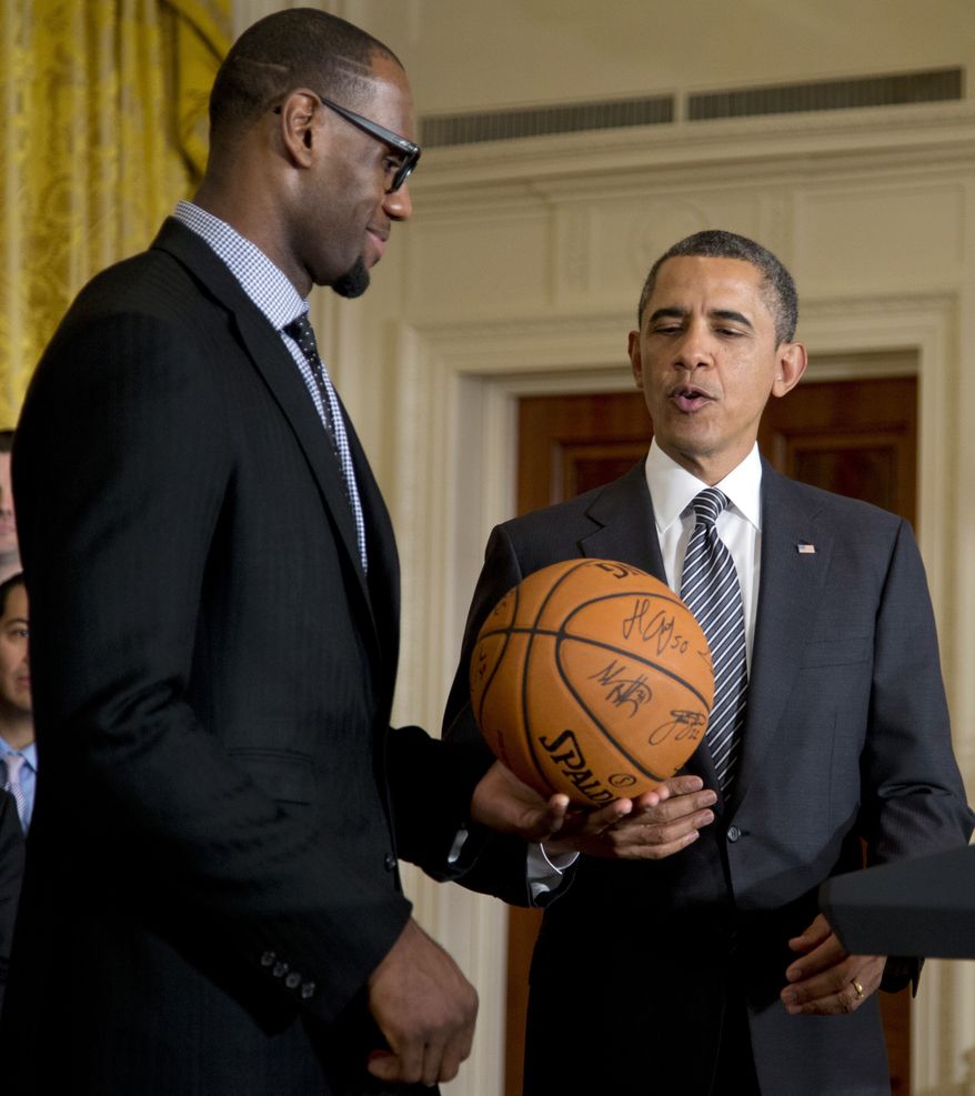 President Barack Obama accepts a signed basketball from Miami Heat forward LeBron James as he welcomes the the NBA basketball champion Miami Heat, to the East Room of the White House, Monday, Jan. 28, 2013, in Washington. (AP Photo/Carolyn Kaster) **FILE**