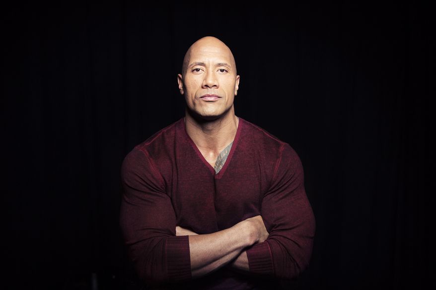 In this Dec. 8, 2014, photo, Dwayne "The Rock" Johnson poses in New York to promote his TNT reality series "Wake Up Call," premiering Friday at 9 p.m. ET. (Photo by Taylor Jewell/Invision/AP) ** FILE **