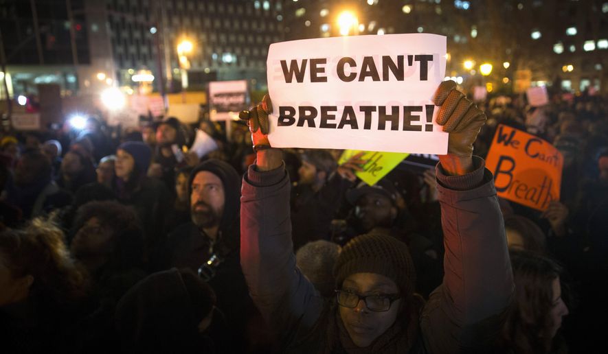 In this Dec. 4, 2014 file photo, demonstrators participate in a rally against a grand jury's decision not to indict the police officer involved in the death of Eric Garner, in New York. (AP Photo/John Minchillo, File)