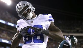 Dallas Cowboys&#39; Dez Bryant (88) reacts after scoring a touchdown during the first half of an NFL football game against the Philadelphia Eagles, Sunday, Dec. 14, 2014, in Philadelphia. (AP Photo/Matt Rourke)