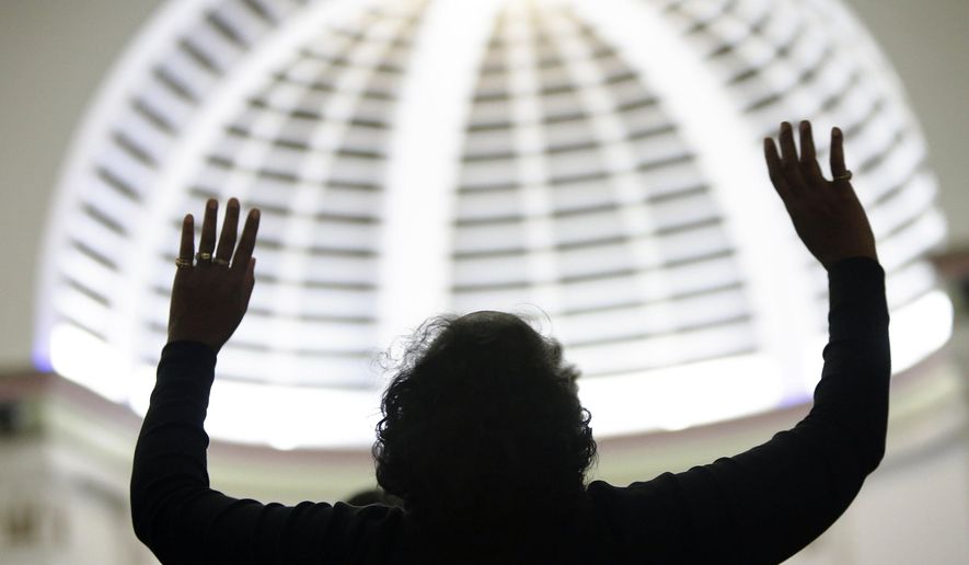 Attending religious services regularly is associated with being "very happy," says a new study from the Austin Institute for the Study of Family and Culture in Texas. (AP Photo/The Muskegon Chronicle, Tommy Martino)