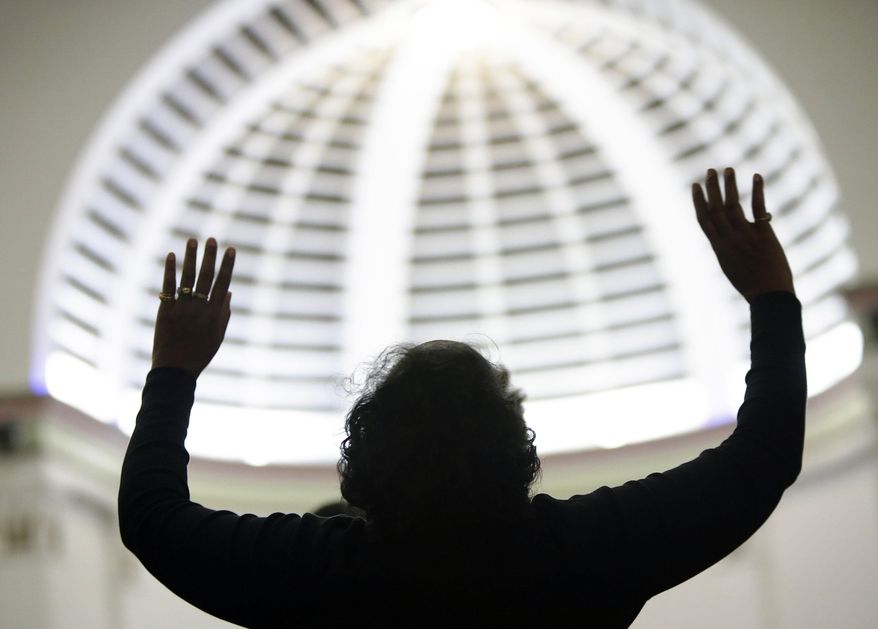 Attending religious services regularly is associated with being "very happy," says a new study from the Austin Institute for the Study of Family and Culture in Texas. (AP Photo/The Muskegon Chronicle, Tommy Martino)