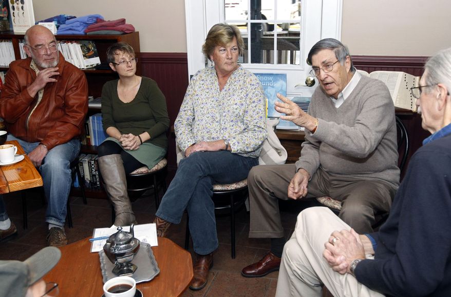 ADVANCE FOR MONDAY DEC. 14 AND THEREAFTER This Dec. 4, 2014 photo shows Scottsville mayor, Barry Grove, left, Chamber of Commerce president Petra Monaco, second from left, Pam Steven, center, Larry Barnett and Ron Smith, right, talk about the economic forecast for the town of Scottsville at Baine's Books & Coffee in Scottsville, Va. Finding businesses to fill vacant storefronts is a concern for any community, but officials and business leaders in Albemarle County's only incorporated town say they have a concern that's even greater. (AP Photo/The Daily Progress, Ryan Kelly)