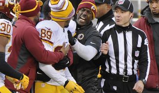 Washington Redskins wide receiver Santana Moss (89) is held back by teammates as he argues with a referee at the end of the first half against the New York Giants during an NFL football game, Sunday, Dec. 14, 2014, in East Rutherford, N.J. (AP Photo/Bill Kostroun)