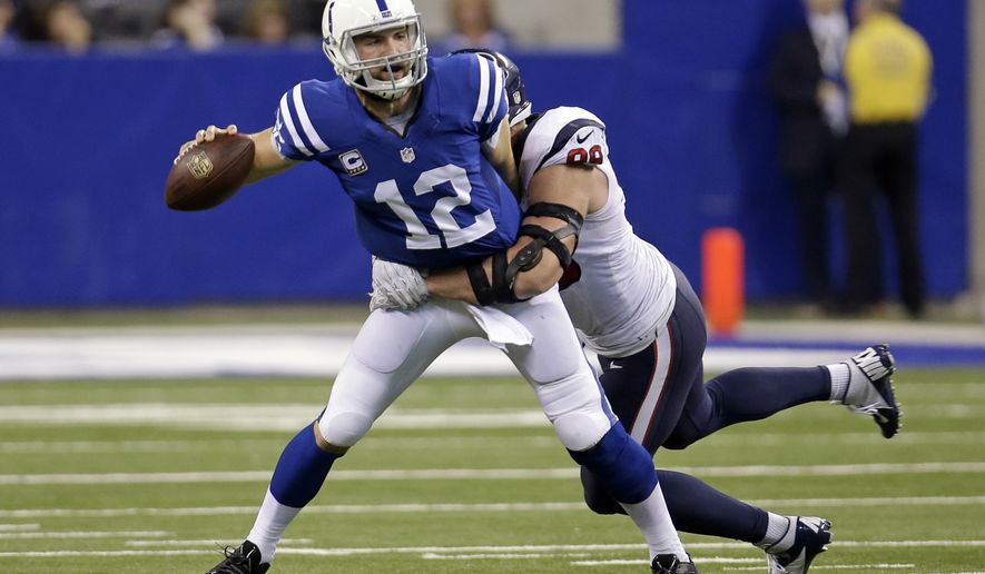 Houston Texans defensive end J.J. Watt, right, sacks Indianapolis Colts quarterback Andrew Luck during the first half of an NFL football game in Indianapolis, Sunday, Dec. 14, 2014. (AP Photo/AJ Mast)