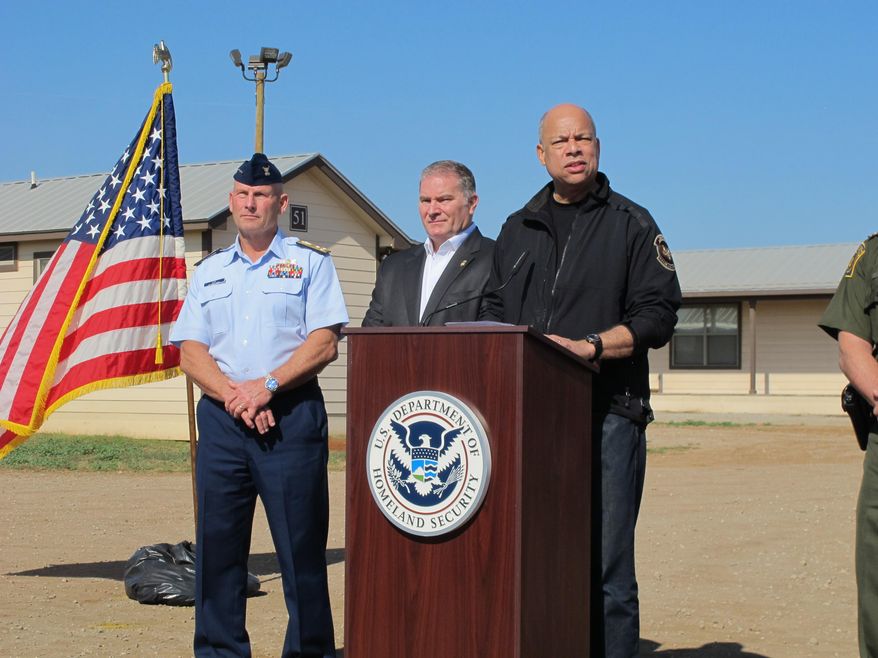 U.S. Homeland Security Secretary Jeh Johnson addresses reporters after touring a new family immigration detention center in Dilley, Texas, on Monday, Dec. 15, 2014. Opening following a summer surge of children crossing the U.S.-Mexico border illegally, the compound features cottages and will have an initial capacity of 480 growing to 2,400 around May _making it the nation’s largest family immigration lockup. (AP Photo/Will Weissert)