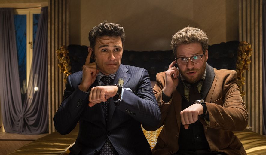 This image released by Columbia Pictures shows James Franco (left) and Seth Rogen in a scene from &quot;The Interview.&quot; An email Tuesday from hackers calling themselves the Guardians of Peace hints that there will be attacks at theaters timed to the release of the Sony comedy opening Dec. 25 that depicts two bumbling journalists recruited by the CIA to assassinate North Korean leader Kim Jong-un. (Associated Press)