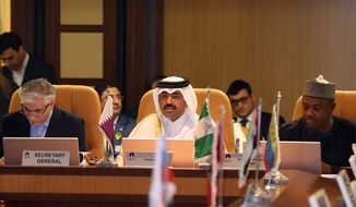 Qatari Oil Minister Mohammed bin Saleh al-Sada, center, speaks during the Gas Exporting Forum where gas exporting countries had their 16th ministerial meeting in Doha, Qatar, Tuesday, Dec. 16, 2014. (AP Photo/Osama Faisal)
