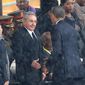 In this Tuesday Dec. 10, 2013, file photo, U.S. President Barack Obama shakes hands with Cuban President Raul Castro, as it rains during a memorial service for former South African President Nelson Mandela, at the FNB Stadium in Soweto, South Africa. (AP Photo/File) ** FILE **