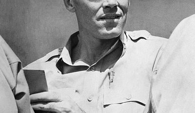 Lieutenant Henry Fonda, former Hollywood movie star, relaxes in a South Pacific area, July 10, 1944 where he is now on active duty on the staff of Vice Adm. J.H. Hoover, U.S. Navy commander of the forward area, Central Pacific. Fonda joined the navy as an ordinary seaman. (AP Photo)
