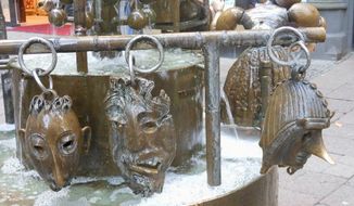 Bronze heads on bottom of Puppet (Doll) Fountain 
 By Corinna Lothar/Special to the Washington Times