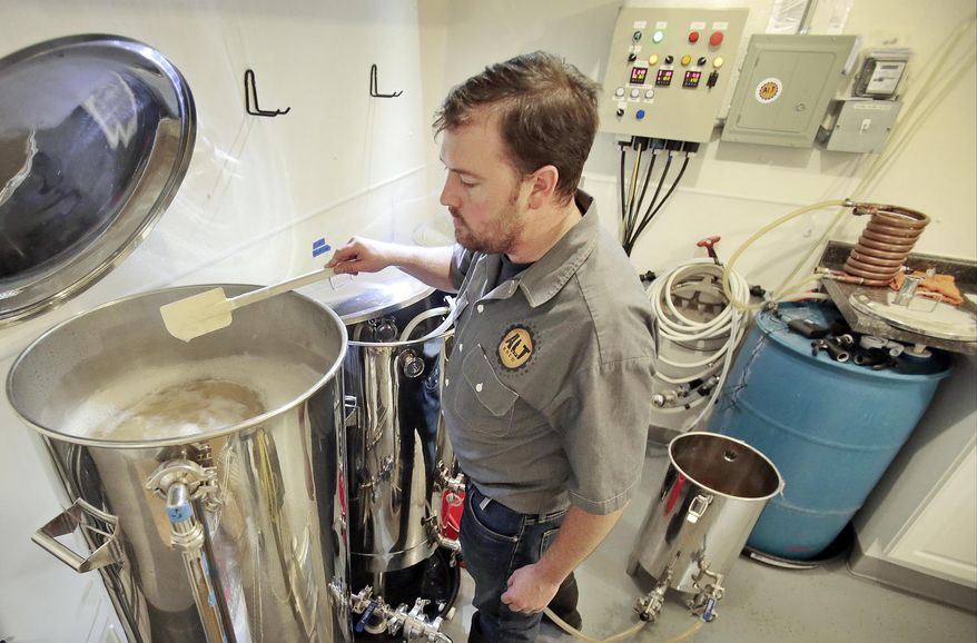 Trevor Easton watches a batch of Hollywood Nights Blonde IPA closely to prevent it from boiling-over at Greenview Brewery inside House of Brews in Madison, Wis., Wednesday, Dec. 10, 2014. Since May, Easton has shunned traditional beer ingredients like wheat, barley and rye to make a line of gluten-free beers. (AP Photo/Wisconsin State Journal, M.P. KING)