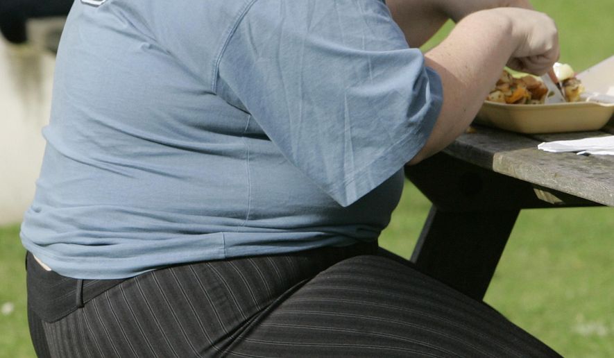 In this Wednesday, Oct. 17, 2007, file photo, an overweight person eats at a bench in London. The European Court of Justice says obesity can be a disability, a ruling that could have consequences for employers across the continent. (AP Photo/Kirsty Wigglesworth, file)