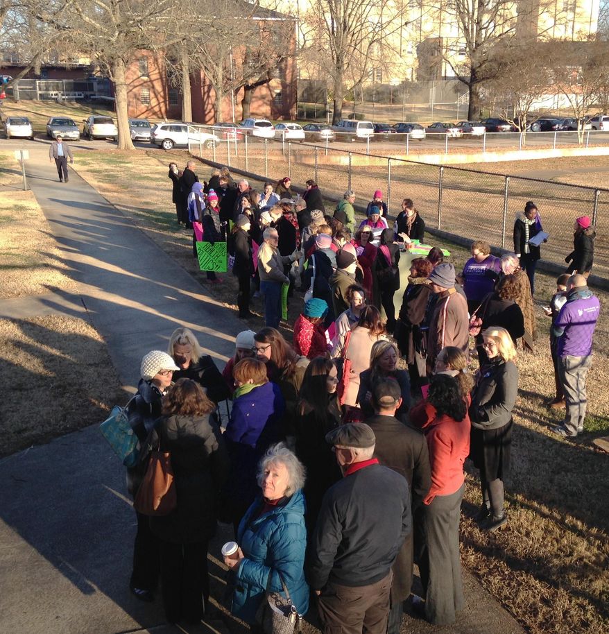 Abortion-rights demonstrators rally before heading into a hearing on abortion regulations for North Carolina in Raleigh on Friday, Dec. 19, 2014. (AP Photo/Jonathan Drew)