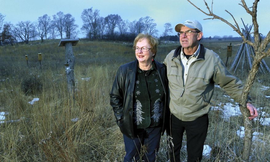 In this photo taken on Dec. 14, 2014, Marti and Ron Martin stand on the winter-time prairie that they created around their home in rural Milton, Wis.. More than 20 years ago, the Martins turned a love of nature into one of the area's first land restoration businesses. (AP Photo/The Janesville Gazette, Bill Olmsted)