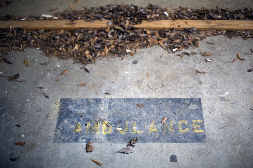 In this April 25, 2014 photo, a faint marking for what used to be a designated ambulance parking spot sits on the pavement outside the now closed emergency room of Flint River Community Hospital, in Montezuma, Ga. A rule allowing struggling rural hospitals to become free-standing emergency rooms appears to be a failure. Months after the policy was adopted, not a single hospital has tried to take advantage of it. Gov. Nathan Deal’s administration had hoped the change might leave rural communities with at least emergency services, even if they could not support a full-on hospital. Medical executives say the financial model was simply unworkable.(AP Photo/David Goldman)
