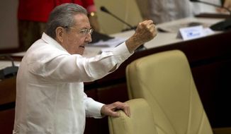 Cuba&#39;s President Raul Castro raises his fist and shout&#39;s during the closing of the twice-annual legislative session at the National Assembly in Havana, Cuba, Saturday, Dec. 20, 2014. (Associated Press) ** FILE **