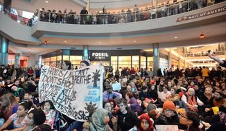 Demonstrators filled the Mall of America rotunda and chanted &amp;quot;Black lives matter&amp;quot; to protest police brutality, Saturday, Dec. 12, 2014, in Bloomington, Minn.  The group Black Lives Matter Minneapolis had more than 3,000 people confirm on Facebook that they would attend. Attendance figures weren&#39;t immediately available. (AP Photo/The Star Tribune, Aaron Lavinsky)