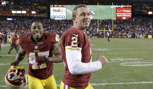 Washington Redskins kicker Kai Forbath (2) and defensive back Akeem Davis (47) leave the field after an NFL football game against the Philadelphia Eagles in Landover, Md., Saturday, Dec. 20, 2014. The Redskins defeated the Eagles 27-24. (AP Photo/Patrick Semansky)