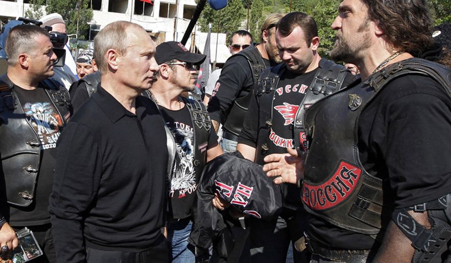Russian President Vladimir Putin, left, speaks with members of the Night Wolves biker group in the Crimean Peninsula, Ukraine,  July 12, 2012. (Associated Press) ** FILE **