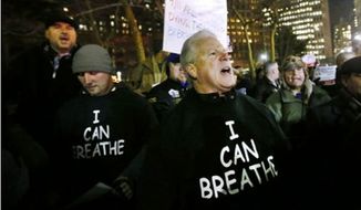 Protesters wear shirts with &quot;I can breathe&quot; on the front and &quot;thanks to the NYPD&quot; on the back during a rally in support of the New York City Police Department, Friday, Dec. 20, 2014. (Image: Twitter, The Independent)