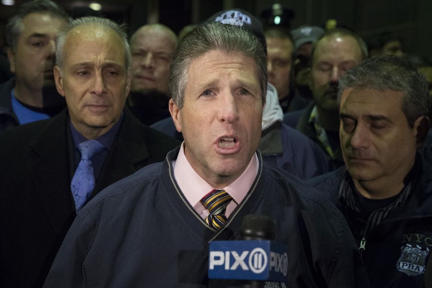 Patrick Lynch, head of the Patrolmen's Benevolent Association, speaks during a news conference after the bodies of two fallen NYPD police officers were transported from Woodhull Medical Center Saturday. An armed man walked up to two New York Police Department officers sitting inside a patrol car and opened fire Saturday afternoon, killing both officers before running into a nearby subway station and committing suicide, police said. (AP Photo/John Minchillo)