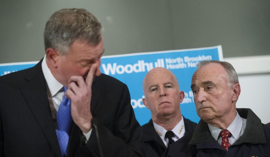 Some Republicans are blaming New York Mayor Bill de Blasio (left) for creating an anti-cop atmosphere that may have indirectly led to the slaying of two police officers over the weekend.  (AP Photo/John Minchillo)  