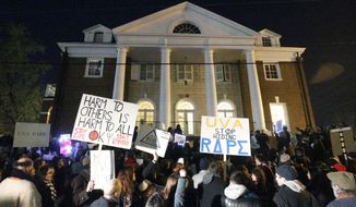 Protestors carry signs and chant slogans in front of the Phi Kappa Psi fraternity house at the University of Virginia on Nov. 22. The Phi Kappa Psi fraternity house was vandalized amid a controversy over a retracted rape story. The attack could amount to a felony, but police have not arrested or charged anyone. (Associated Press)