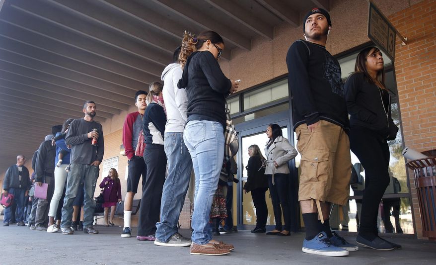 A line stretches outside an a Arizona Department of Transportation Motor Vehicle Division office, as many young immigrants protected from deportation under new Obama administration policies begin pursuing Arizona driver&#39;s licenses, Monday, Dec. 22, 2014, in Phoenix. (AP Photo/Ross D. Franklin) ** FILE **