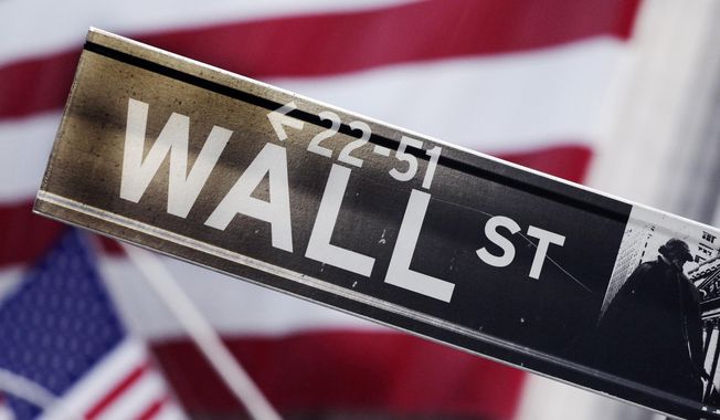 This Aug. 9, 2011, file photo shows a Wall Street street sign near the New York Stock Exchange, in New York. (AP Photo/Mark Lennihan, File)