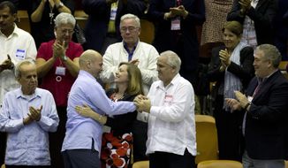 In this Dec. 20, 2014 photo, Cuba’s head of North American affairs, Josefina Vidal, front row center, embraces Gerardo Hernandez, member &quot;The Cuban Five,&quot; at the closing from a twice-annual legislative session at the National Assembly in Havana. (AP Photo/Ramon Espinosa)
