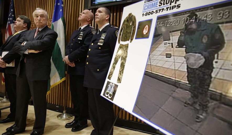 New York City Police Commissioner Bill Bratton, second from left, looks at a video frame of Ismaaiyl Brinsley during a news conference at police headquarters in New York, Monday, Dec. 22, 2014. Police are asking for the public&#x27;s help in identifying his whereabouts before he killed two police officers and himself on Saturday afternoon. (AP Photo/Seth Wenig)