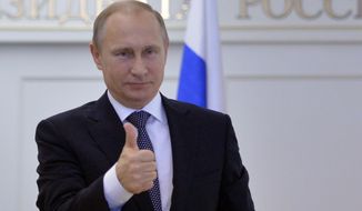Russian President Vladimir Putin gives thumbs up during a live video link with Plesetsk Cosmodrome, as he watches a launch of Angara-A5 rocket booster in Moscow, Russia, on Tuesday, Dec. 23, 2014. (AP Photo/RIA Novosti, Alexei Druzhinin, Presidential Press Service) **FILE**