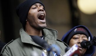 Dontre Hamilton&#39;s brother, Nate Hamilton yells on the steps of the federal courthouse Monday, Dec. 22, 2014, in Milwaukee. Milwaukee County District Attorney John Chisholm announced earlier in the day that there would be no charges against former police office Christopher Manney in the fatal shooting of Dontre Hamilton. At right is Maria Hamilton, mother of Dontre Hamilton. (AP Photo/Morry Gash)