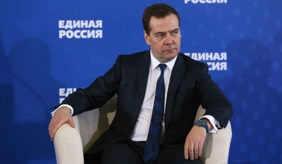 Russian Prime Minister Dmitry Medvedev  listens during a meeting with senior ruling United Russia Party officials in Moscow, Russia on Tuesday, Dec. 23, 2014. Medvedev has warned that the country faces a risk of a &quot;deep recession&quot; if the government ditches its spending plans. (AP Photo/RIA Novosti, Yekaterina Shtukina, Government Press service)
