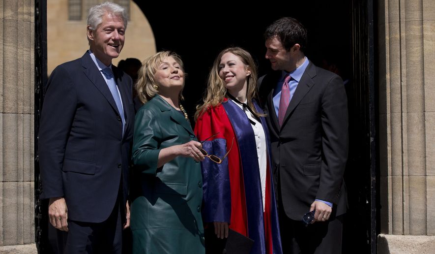 This, May 10, 2014, file photo, shows Former U.S. Secretary of State Hillary Rodham Clinton, second left, as she takes off her sunglasses to pose for a group photograph with her husband former U.S. President Bill Clinton, left, their daughter Chelsea, second right, and her husband Marc Mezvinsky, as they leave after they all attended Chelsea&#x27;s Oxford University graduation ceremony at the Sheldonian Theatre in Oxford, England. (AP)