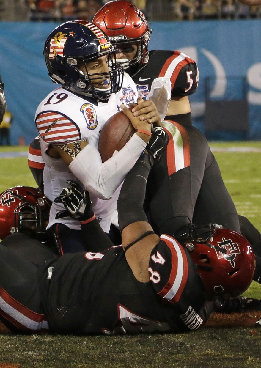 Navy quarterback Keenan Reynolds scores a touchdown against San Diego State during the first half of the Poinsettia Bowl NCAA college football game Tuesday, Dec. 23, 2014, in San Diego. (AP Photo/Gregory Bull)