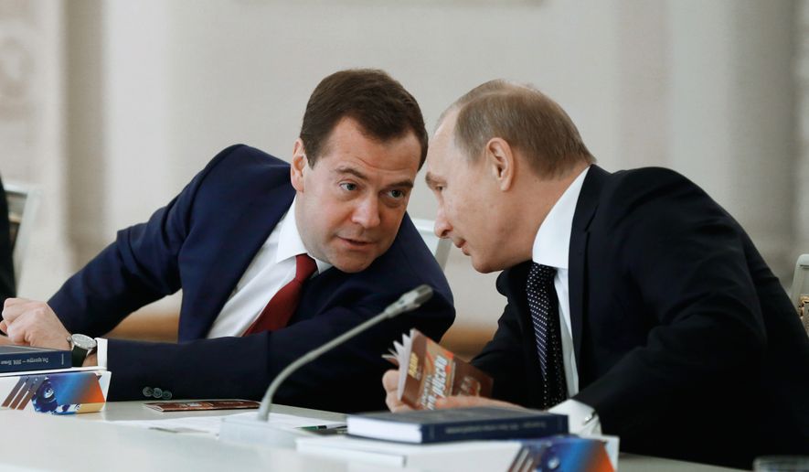 Russian President Vladimir Putin and Russian Prime Minister Dmitry Medvedev, left, talk during the meeting of the State Council in Moscow&#39;s Kremlin, Russia, on Wednesday, Dec. 24, 2014. The meeting of the State Council focused on government efforts to support culture. (AP Photo/RIA Novosti, Alexei Druzhinin, Presidential Press Service)