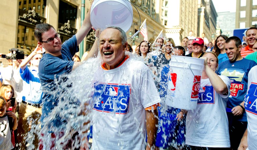 Major League Baseball Commissioner-elect Rob Manfred participates in the ALS ice bucket challenge outside the organization&#39;s headquarters in New York in August. The campaign raised $115 million through the ice bucket challenge. (Associated Press)