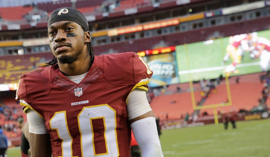 Tough: Washington Redskins quarterback Robert Griffin III has struggled with injuries and coach Jay Gruden&#39;s offense. It wasn&#39;t until Saturday that he achieved his first victory in a complete game since midway through last season. (Associated Press photographs)